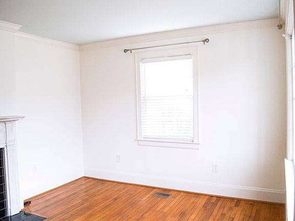 Spacious front Living Room with beautiful large windows looking out.