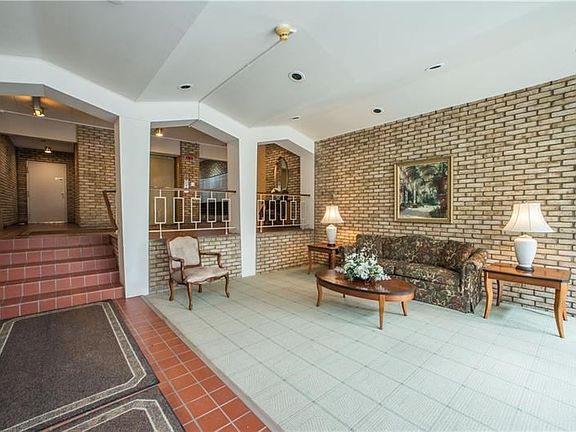 This view of the lobby reveals the elevator, through the center opening on the wall, with a peek of the mailboxes located just t