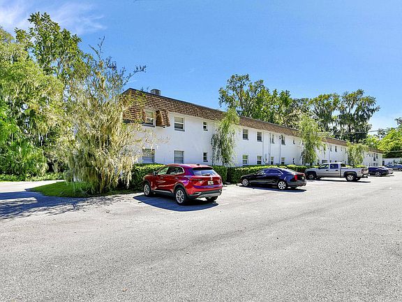 Explore a tranquil apartment setting with ample parking and lush surroundings.