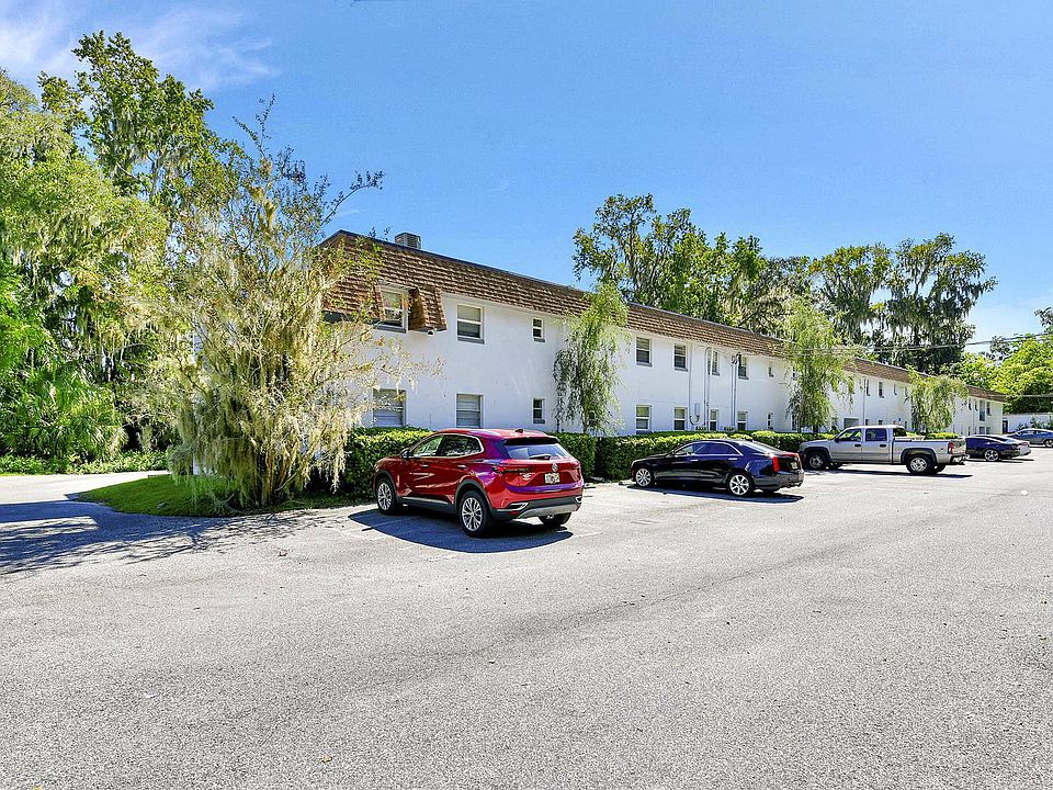 Explore a tranquil apartment setting with ample parking and lush surroundings.