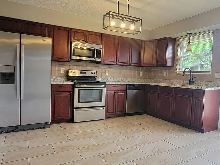 Granite Countertops and Stainless Steel Appliances in Kitchen