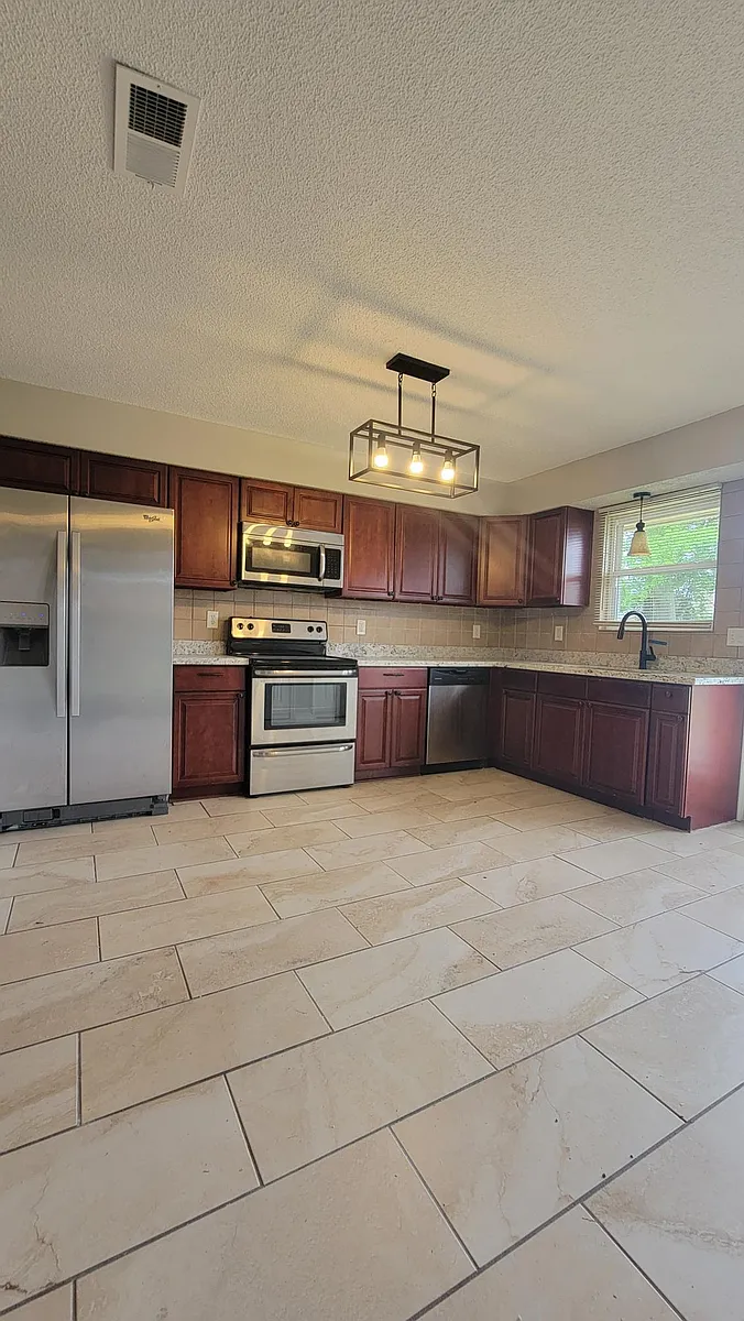 Granite Countertops and Stainless Steel Appliances in Kitchen - 412 Portsmouth Dr