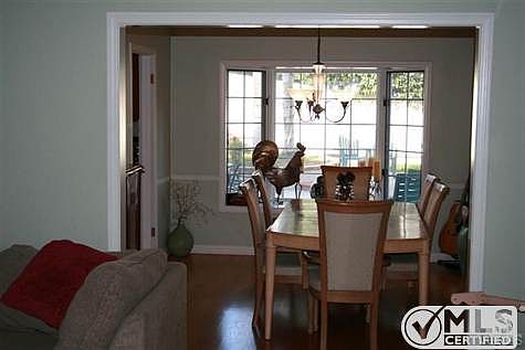 Dining Room open to living room, wood floors, crown molding,