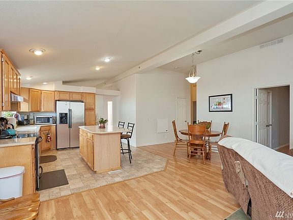 Spacious kitchen features solid surface countertops, range, refrigerator, dishwasher stay