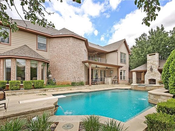 Make a splash in the sparkling saltwater pool & spa or relax on the covered patio living area featuring a built-in TV, ceiling fans & gas fireplace!