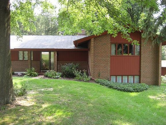 3Be,3Ba and 1 room with built in library and cabinets, wood flooring and walls