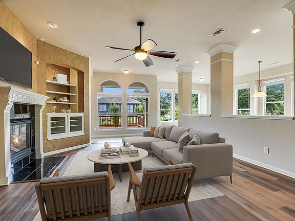 Family room with gas fireplace, built in shelving, glass cabinet for components/ wiring