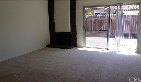 Living Room has fireplace and sliders opening to back patio.