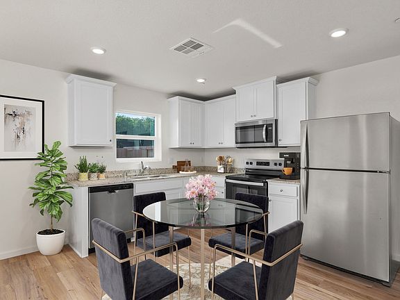 The kitchen is connected to the dining room.