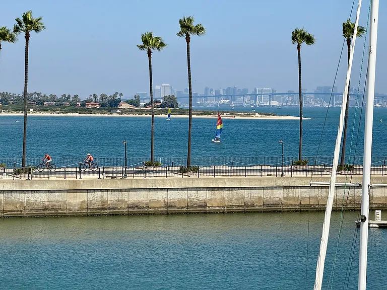 View from Master Bedroom balcony/deck showing recreational opportunities: i.e. - small boat sailing, kayaking, Stand Up Paddleboarding, and bike riding all easily accessible nearby. Also nearby are tennis courts, soccer fields, playgrounds & a dog run.