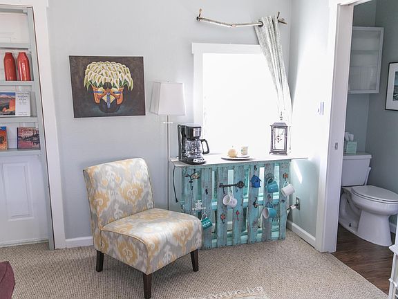 Living room area with TV, sitting area and ceiling fan