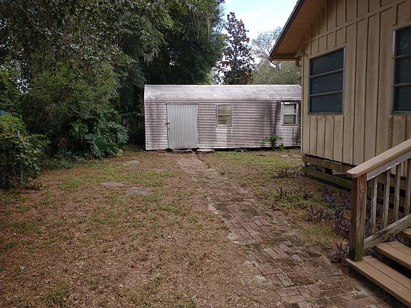Back of house with large shed