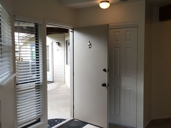 View from the inside to the entry way, showing large closet behind entry door.