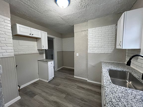 New kitchen with granite countertops, (stainless steel appliances installed after the pic was taken).