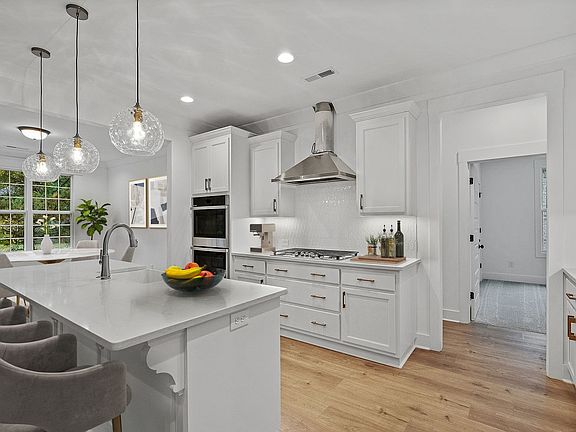 Gourmet kitchen with custom painted cabinets, quartz countertops, upgraded stainless steel appliance