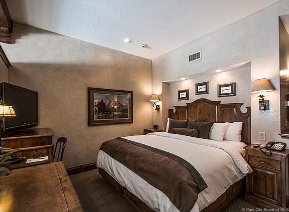 King size bed with luxurious linens and built in desk