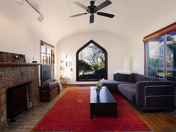 Living room with vintage fireplace and coved ceilings
