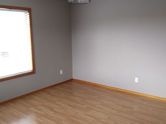 Living area, new laminate floors, new black ceiling fan, new paint