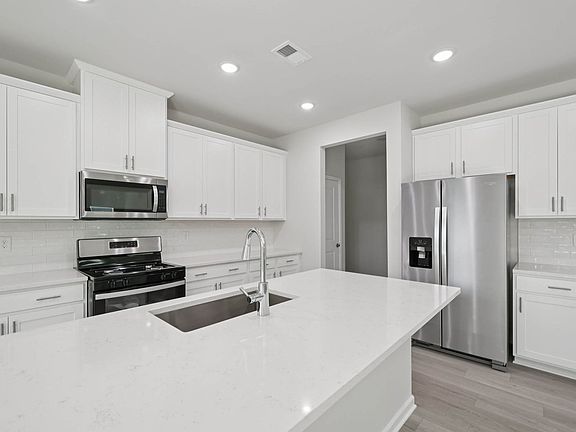 Kitchen in the Taylorsville floorplan at Cadence Meadows in Zebulon, NC.