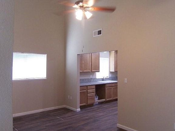 Large dining room is perfect for family gatherings. Did you notice the ceiling fan? Two tone paint throughout.