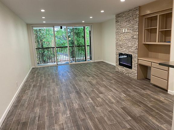 Large living/dining space with entrance to balcony.