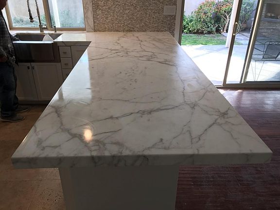 Marble peninsula and sliding back door to patio.