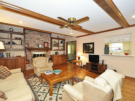 Spacious living area with wood flooring. Notice the built-ins!