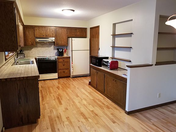 Spacious kitchen with Maple flooring and lots of cabinets and counter space