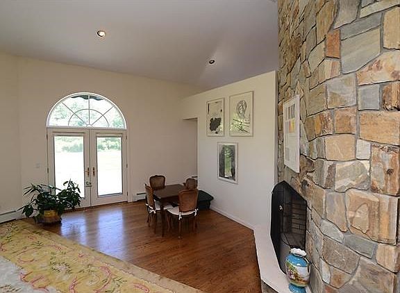 Living room boasts of 2 story stone fireplace (never used) doors to patio with awning.