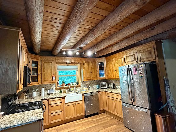 Updated kitchen with granite counter tops and tile floor and back splash, farm sink, newer appliances.