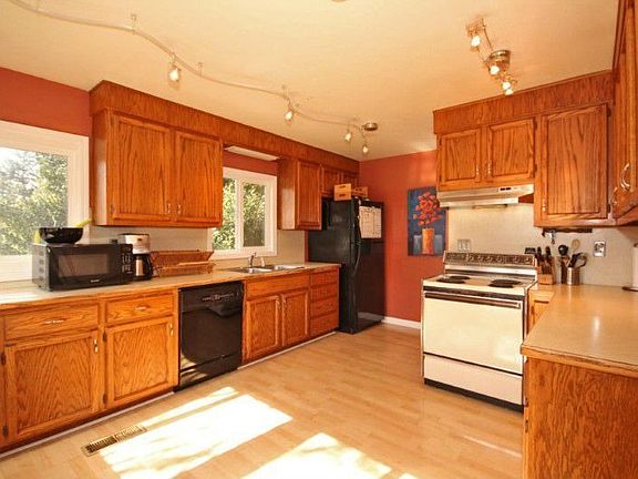 Lots of natural light in this large kitchen. Look at all that counter space , you even have designer lighting when needed.