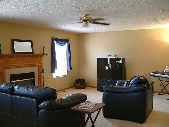 Family room with gas log fireplace and ceiling fan!