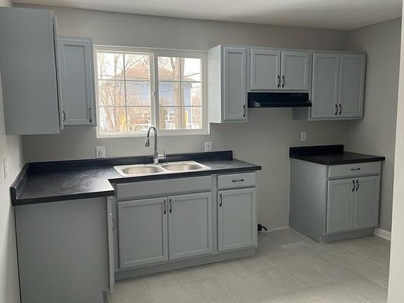 Kitchen has electric cooktop/stove and refrigerator.