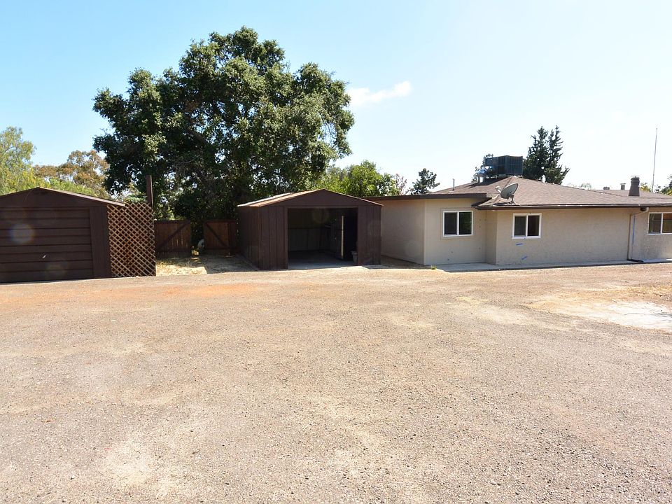 Gated Front Yard with 2 Garages and Massive Room for RV Parking
