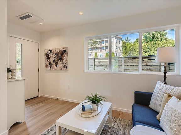 Living area is adjacent to the kitchen. Since the photo, we have also added a chair.