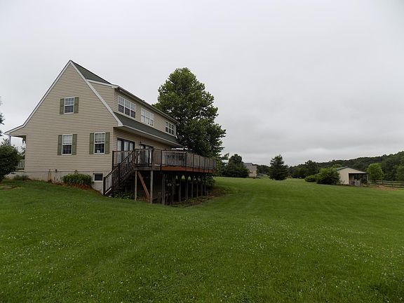 Side showing horse barn and nearest neighbor