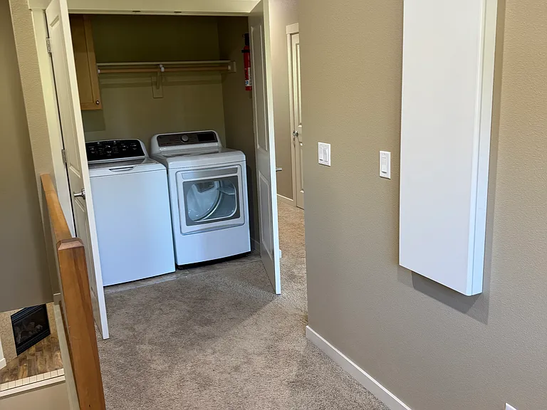 loft area with laundry closet