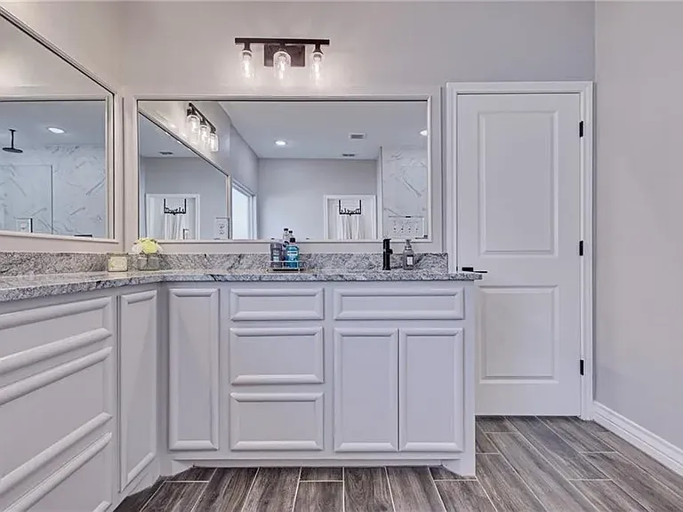 Primary bathroom featuring a double-sink vanity while offering plenty of space and convenience.