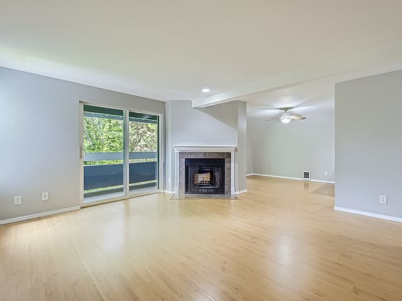 Living hall with wood fireplace and dining view