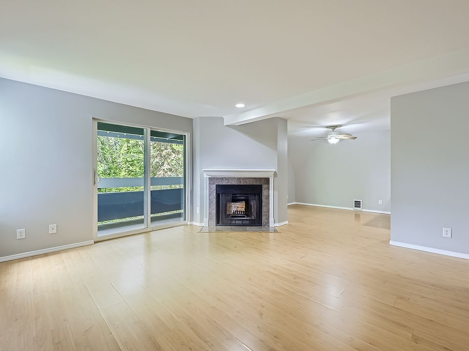 Living hall with wood fireplace and dining view
