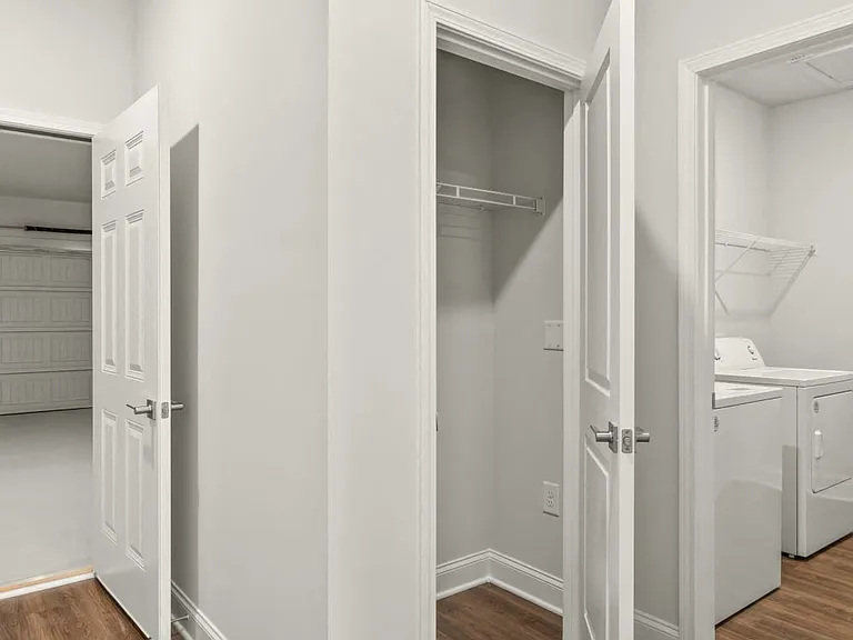 Functional space featuring a coat closet, washer & dryer, and garage access.