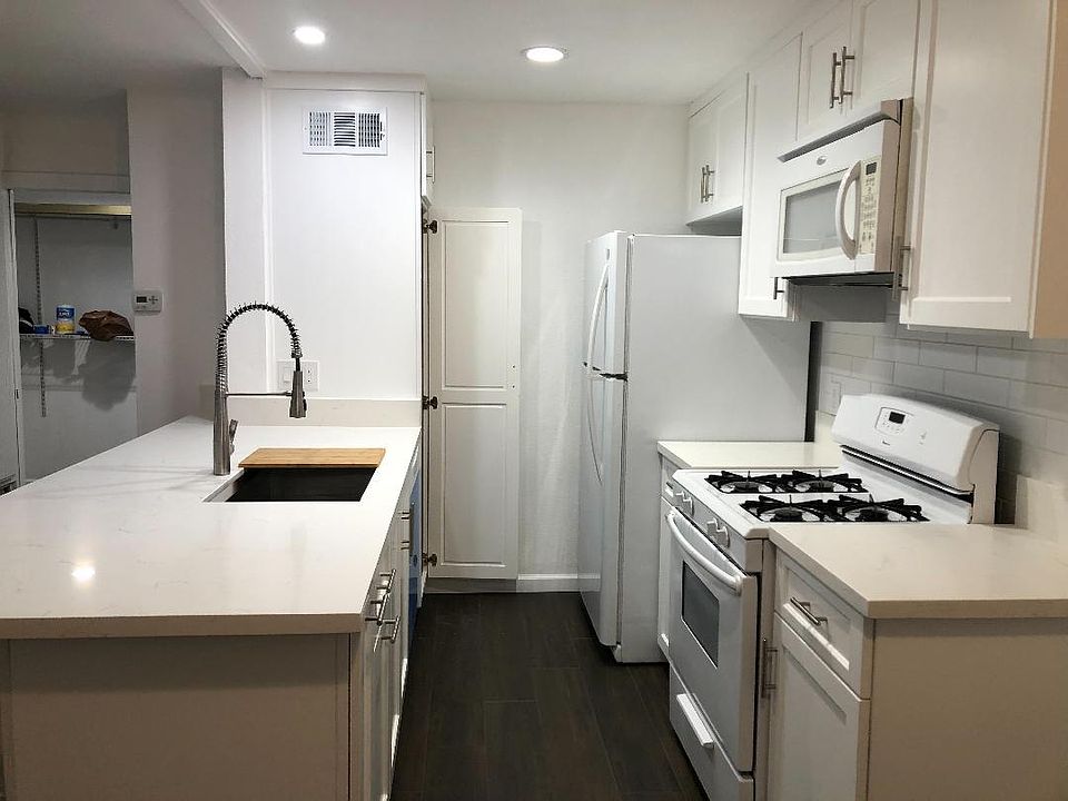 The kitchen while standing in the dining area.