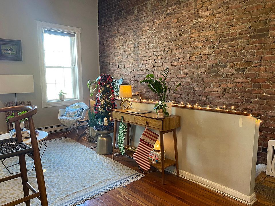 Exposed brick walls and hardwood floors