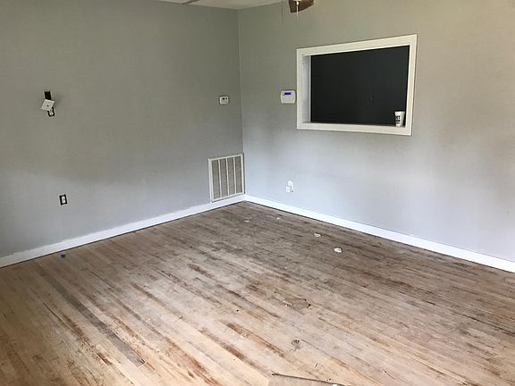 New trim and fresh paint in the living room. Floors will be stained dark walnut