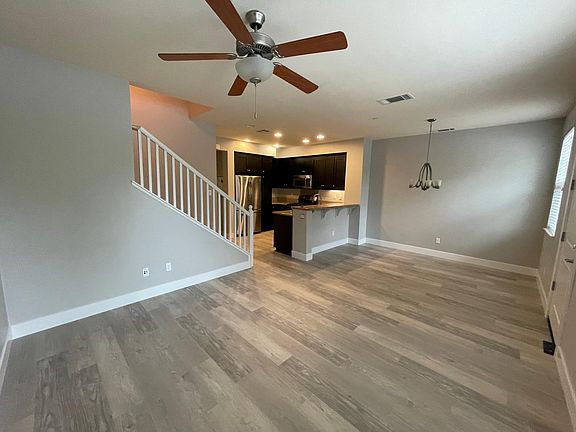 Living Room with newer LVP flooring and Ceiling Fan with Lights
