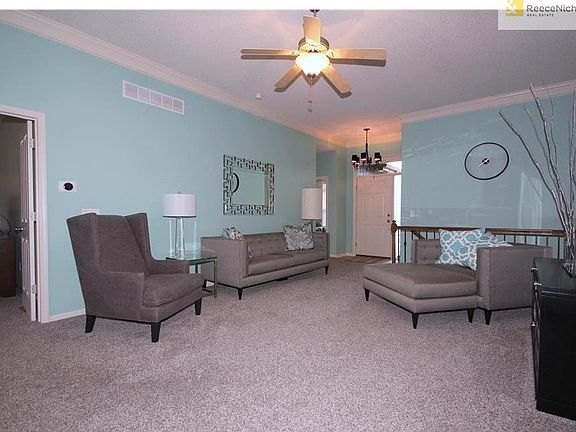 Spacious living room with open staircase, updated spindles and light fixtures.