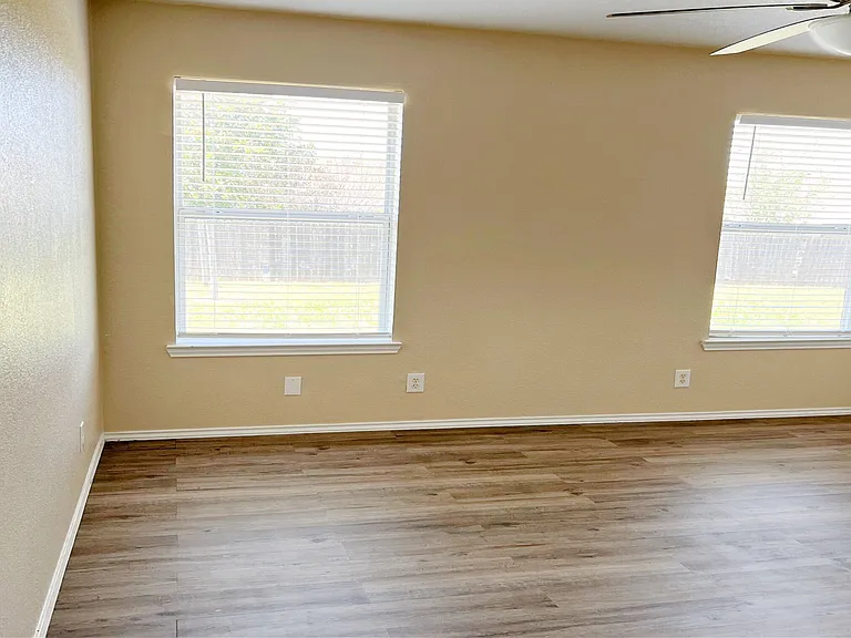 Master bedroom with beautiful wood vinyl plank flooring.