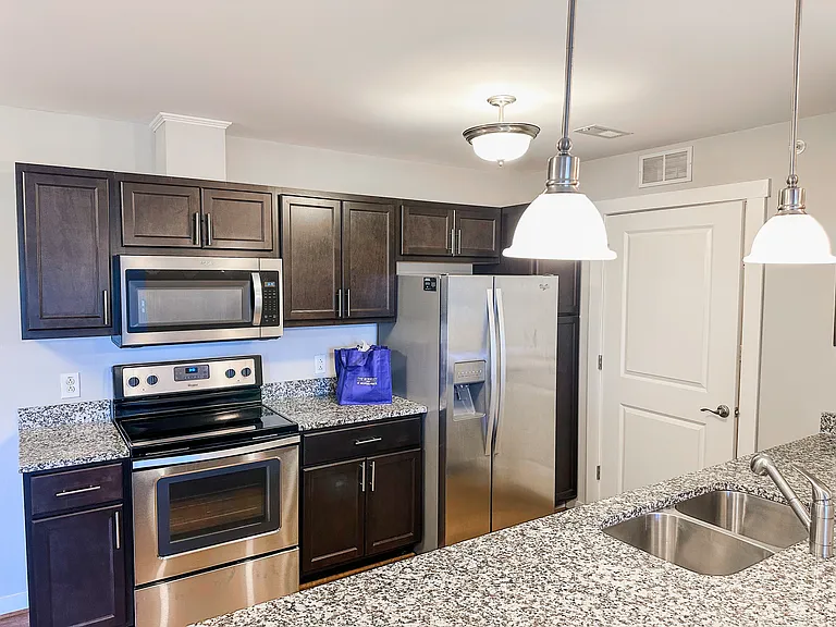 The kitchen features granite countertops and stainless steel appliances.