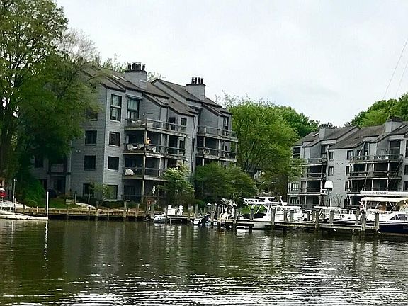 View of 2nd floor condo from a kayak perspective. Person in yellow is on deck.