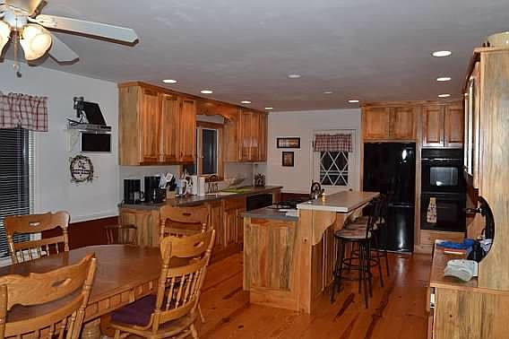 KITCHEN : CUSTOM MADE BLUE PINE CABINETS, PINE FLOORS,CENTER ISLAND STOVE & BREAKFAST BAR